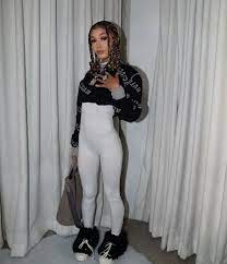 Coi Leray wearing a black and white outfit